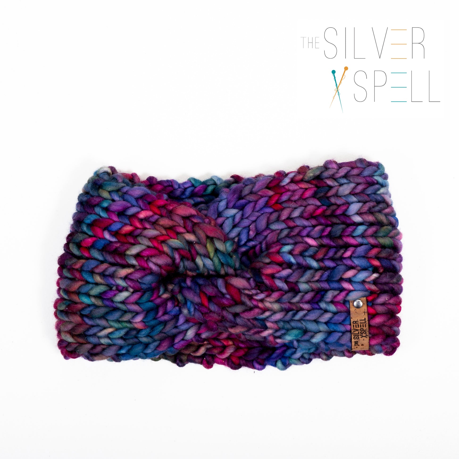 A multicolored hand-knit wool headband on a white background.