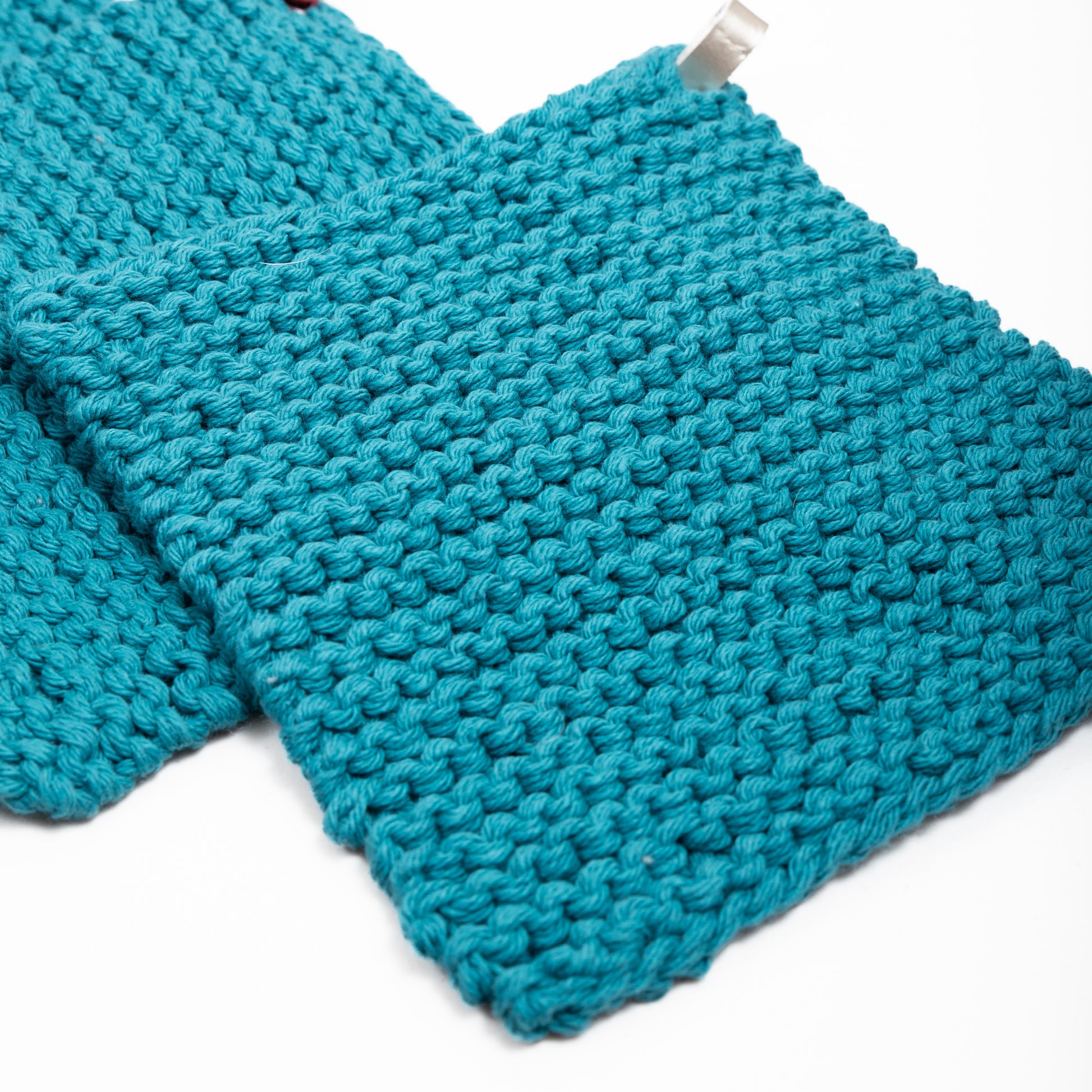 two teal hot pads shown next to each other