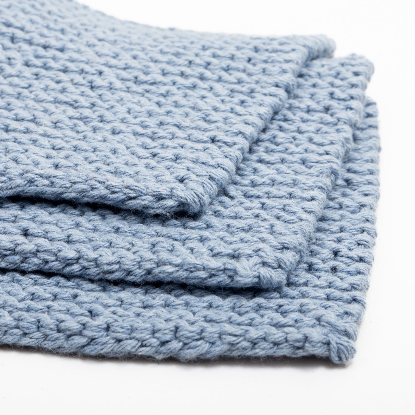 Three towels in blue stocked on top of each other